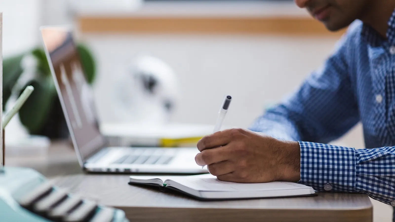 Desk with a notebook and checklist while contract terms are read